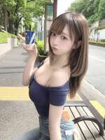[With images] A sexy woman with about half her breasts exposed is photographed at a city bus stop