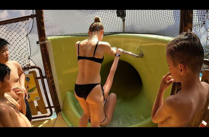 [Image] A bratty boy gets glued to the butt of a swimsuit high school girl while waiting for his turn on a water slide. 3th image